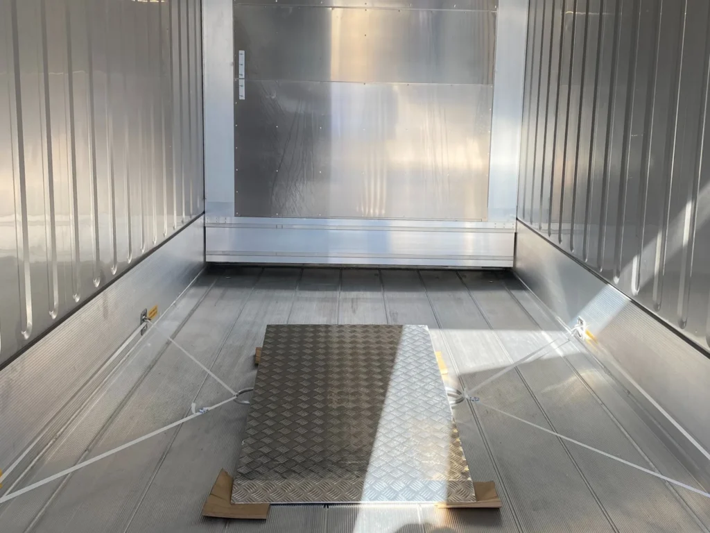 Interior of a 20ft new one trip reefer container with stainless steel walls and insulated flooring.