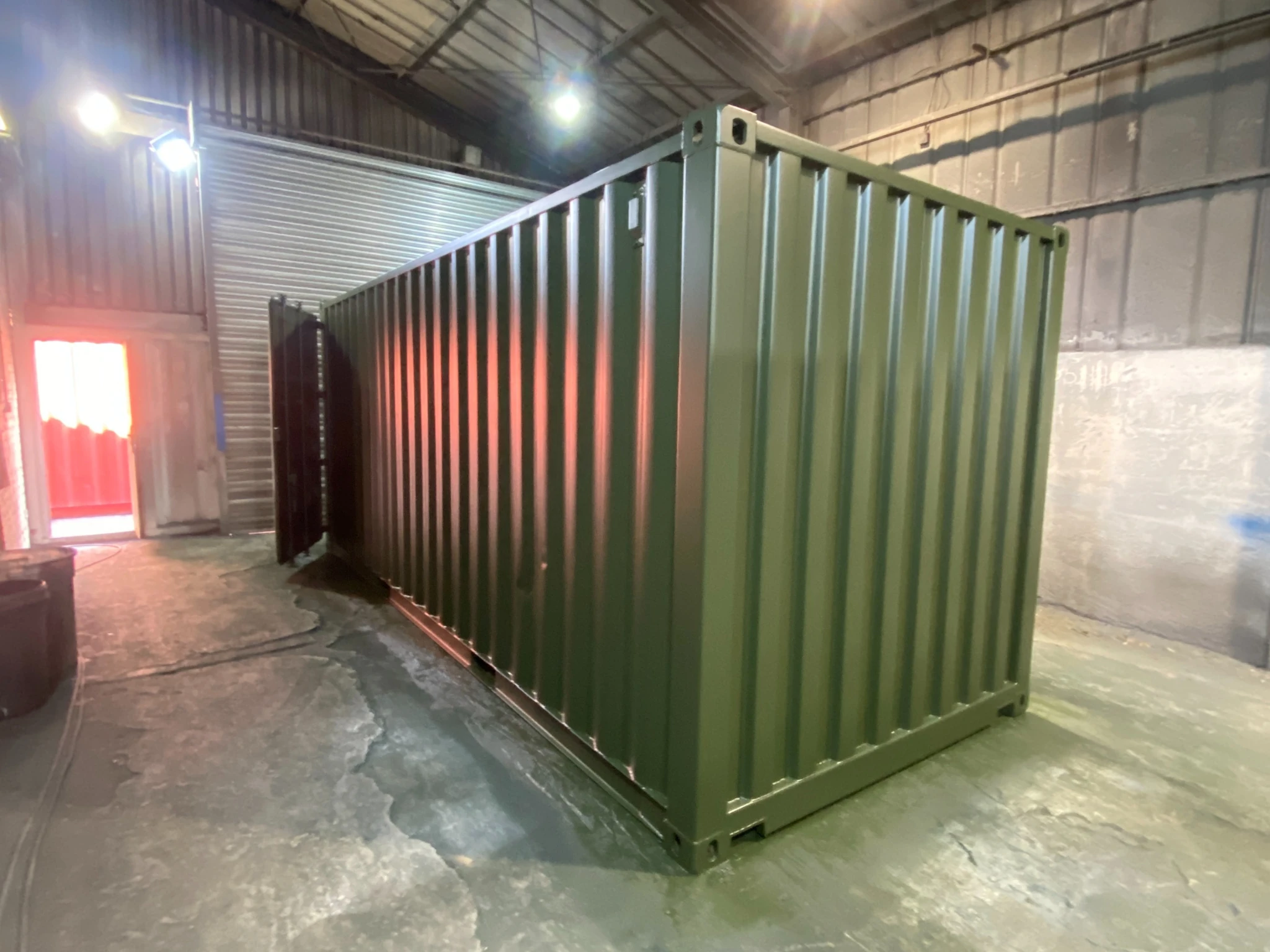 Shipping container freshly painted inside professional spray booth