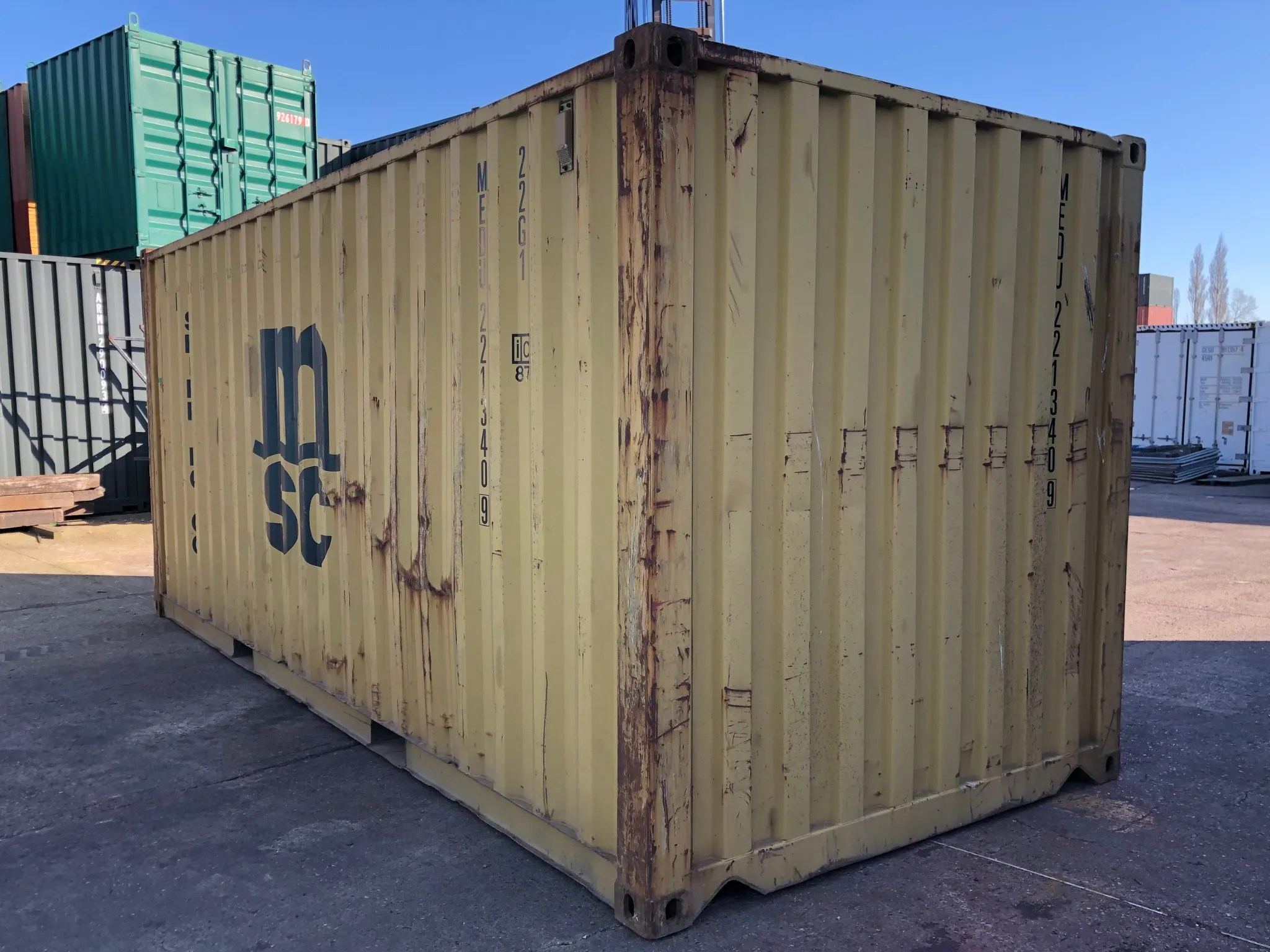 20ft used shipping container in yellow — ex-fleet steel unit with signs of wear, ideal for budget storage, construction site use or agricultural storage UK-wide.