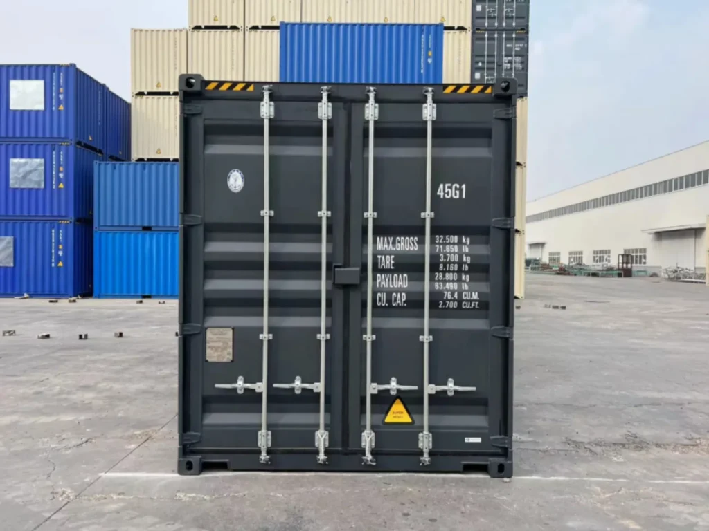 High Cube Containers Rear door view of a new 40ft high cube shipping container, painted dark grey, with visible locking bars and container markings.