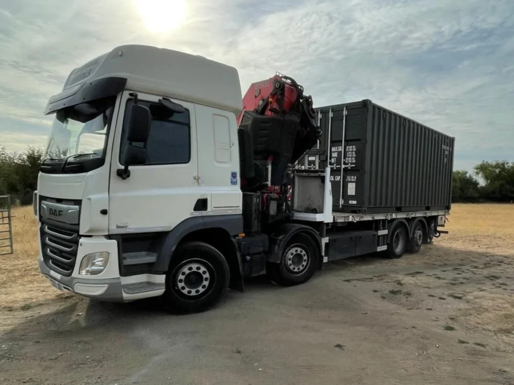 HIAB truck delivering 20ft shipping container on site