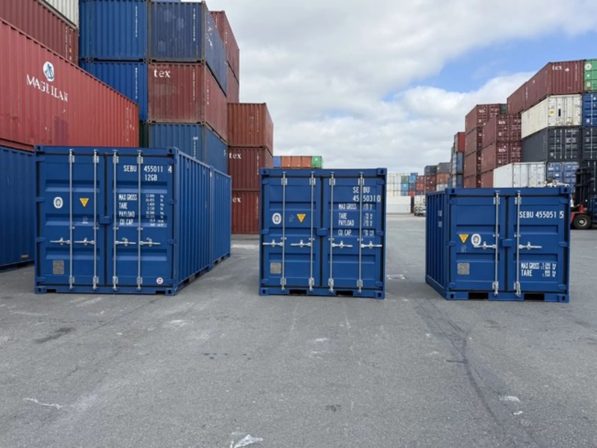 Small storage containers for sale UK – blue 10ft shipping containers in secure depot.