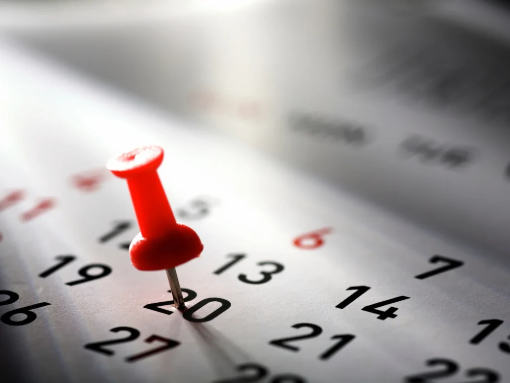 Calendar with a marked date highlighting last minute changes as a common cause of shipping container delivery delays in the UK
