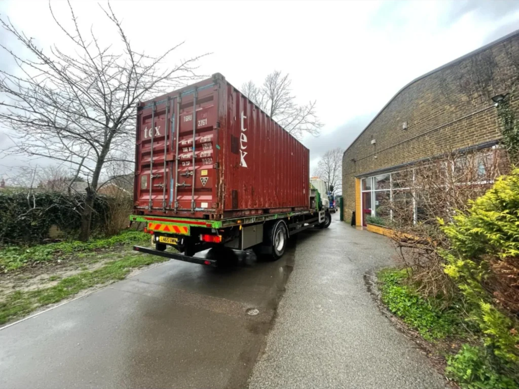 20ft used shipping container being delivered to a school site using a HIAB crane