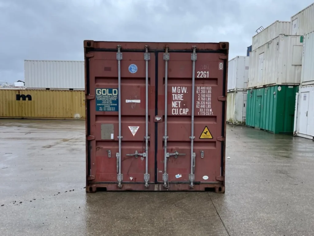 Front view of a red 20ft used shipping container with secure steel doors