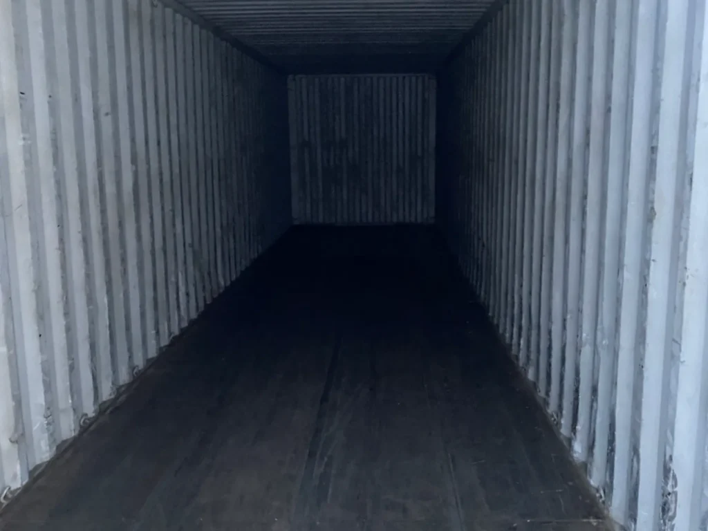 Interior of a 40ft used shipping container with steel walls and timber floor