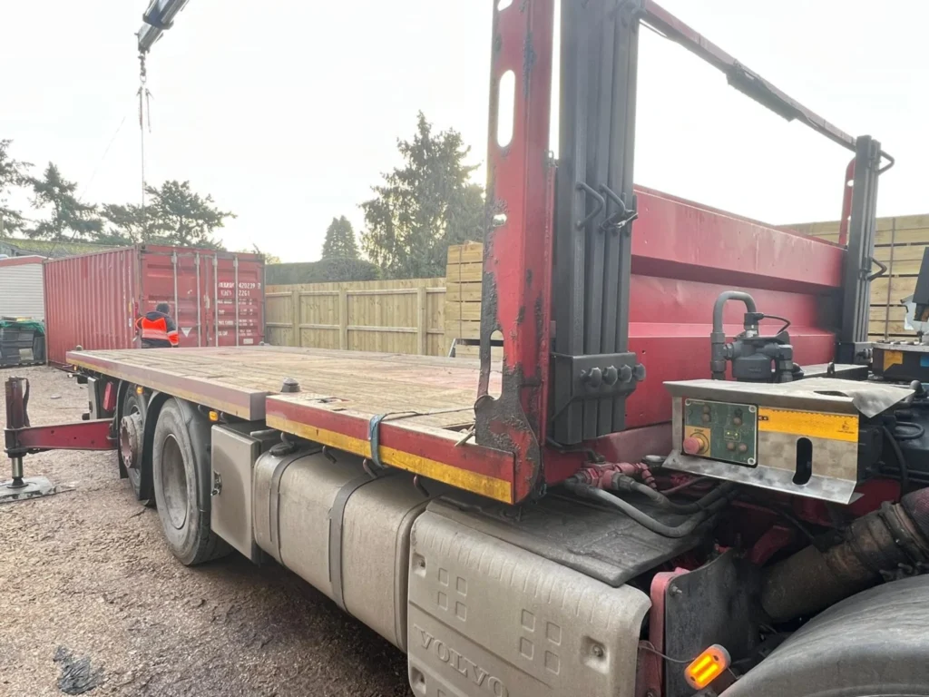 20ft Used Shipping Containers Hiab crane lifting a shipping container into final position during site delivery