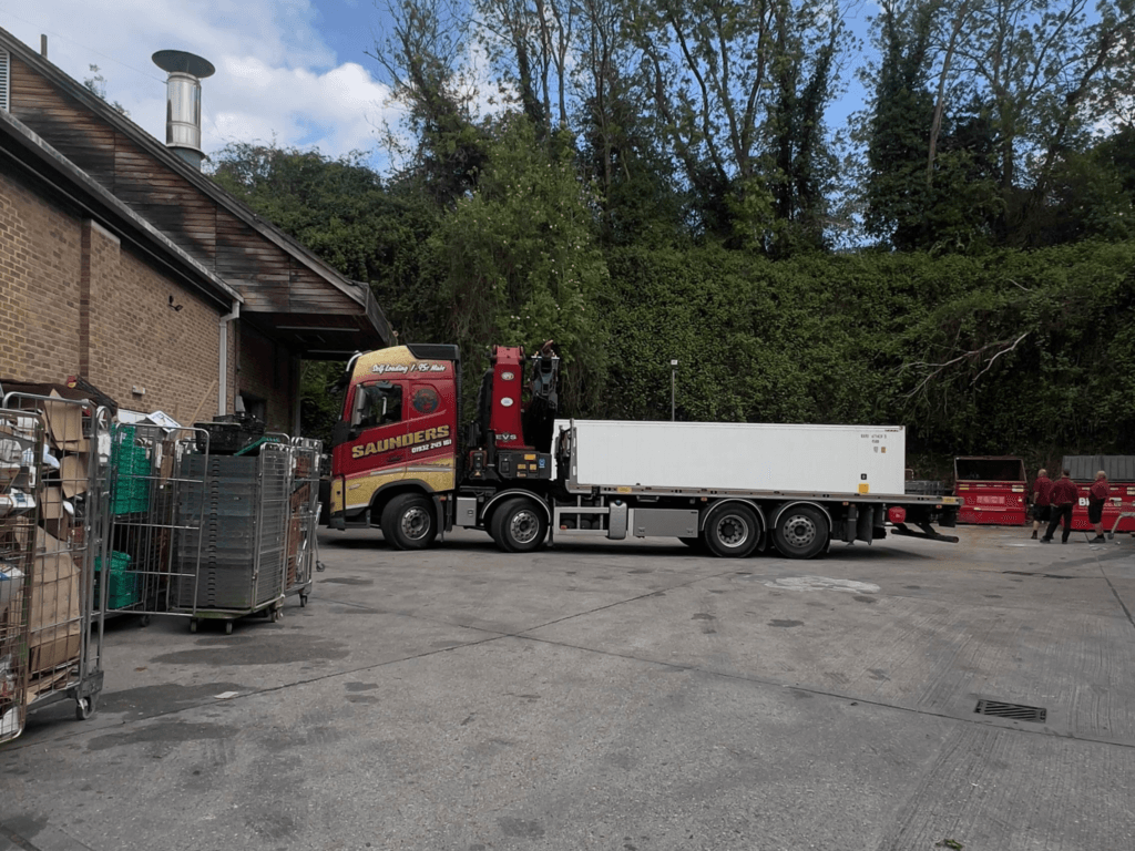 HIAB delivery of a 40ft new high cube refrigerated shipping container at Jempson's Supermarket in Peasmarsh, East Sussex.